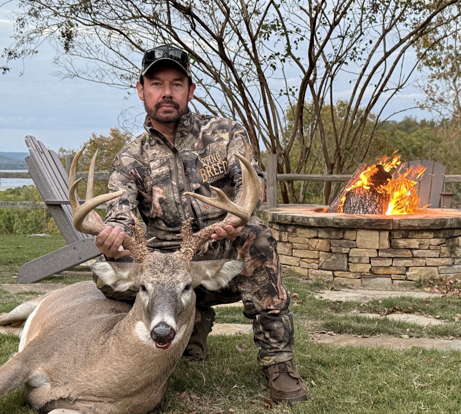 Two hunters with a big-game animal in the mountains