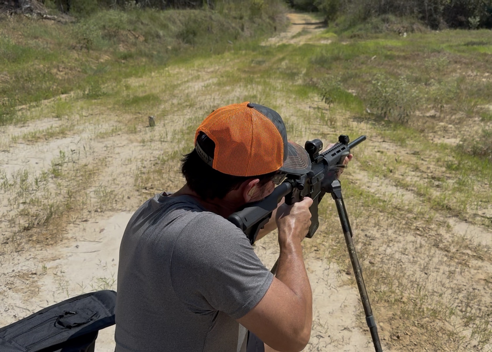 A hunter filming from a field position
