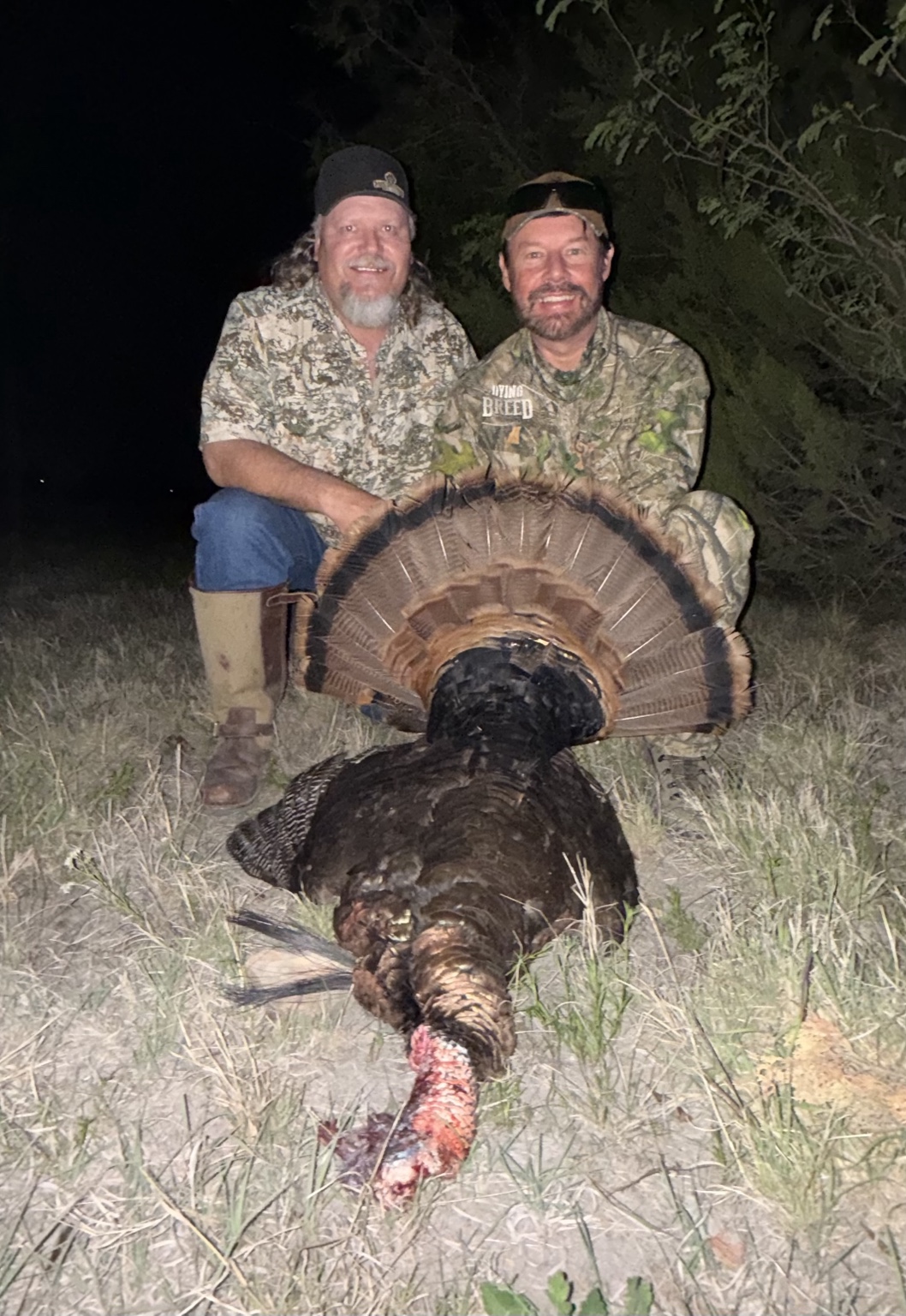 Hunters sharing a nighttime turkey hunting moment